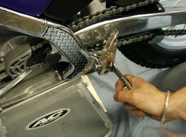 The foot peg mounting bolts are tightened at the factory so that they are in an upright fixed