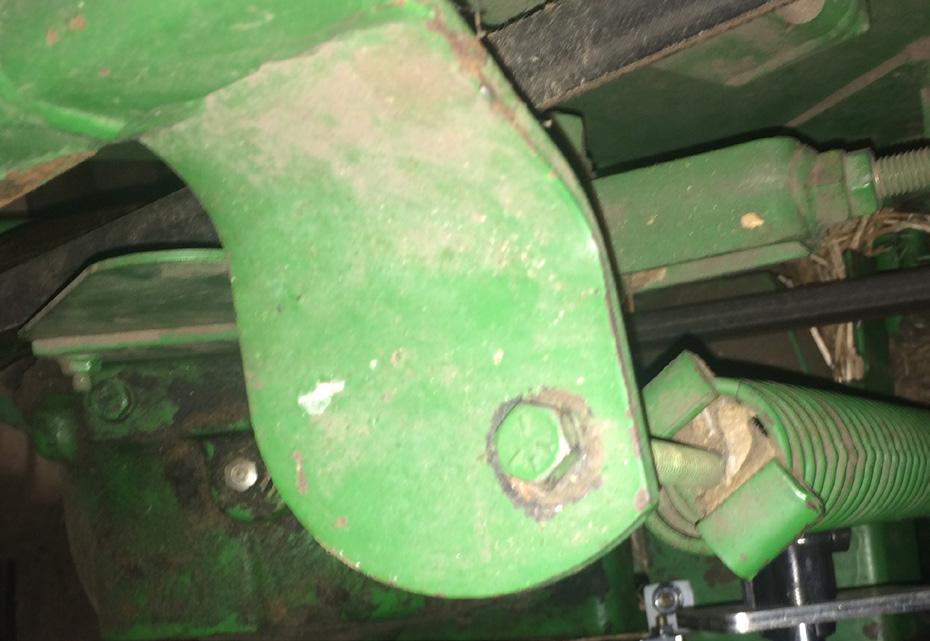 If your header has the bolt out toward the end of the bracket, you must drill a new hole and move the bolt and spring in as shown in the second picture.