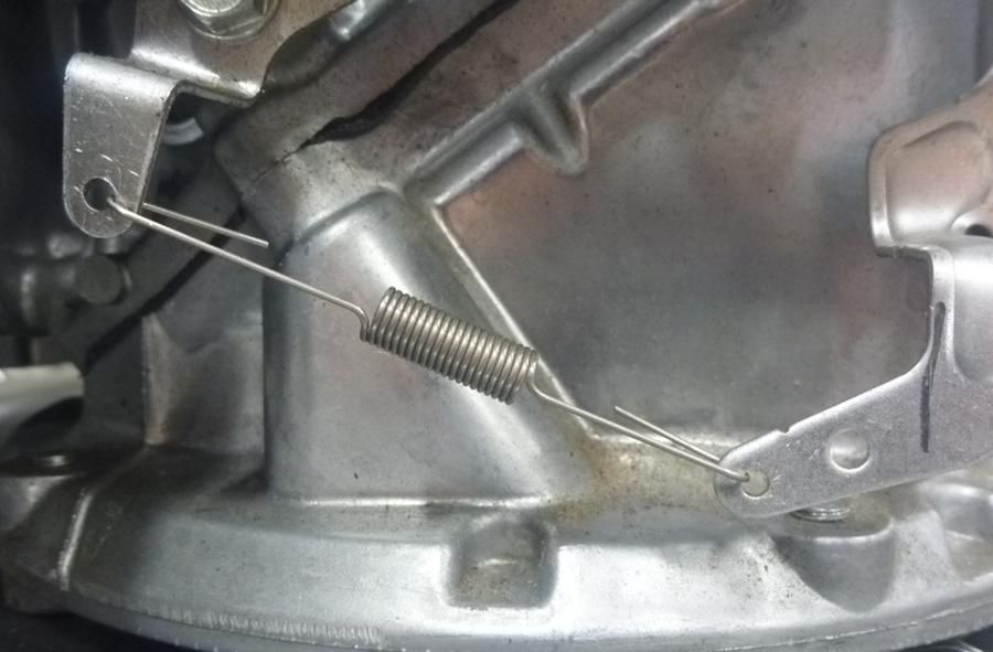 PROCEDURE 1. With the engine off, remove the existing governor spring. 2. Install the new spring. Make sure the hooks are facing inward as shown.