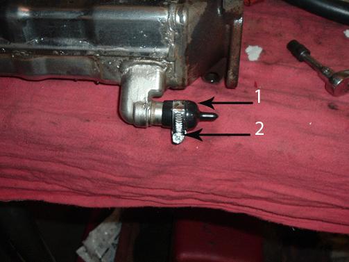 5. Install the Cap Plug(s) (1) and tighten the clamp(s) (2) on the EGR cooler hose barb(s) as shown. 6.