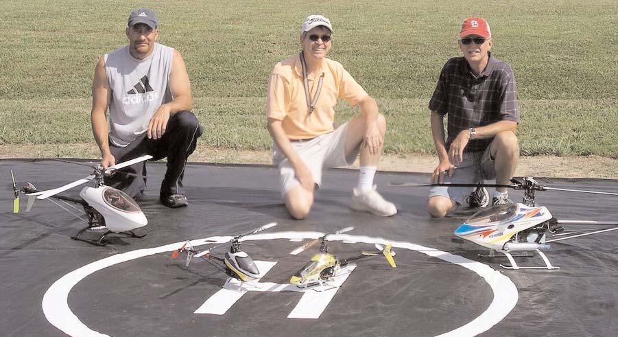 Tom Foster, Pete Stephans and John Smith show off the newly finished helicopter hovering pad. Great work, guys!