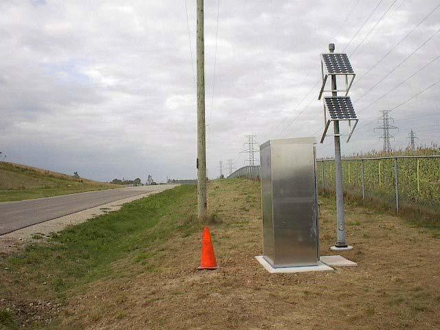 4 shows photoes of the WIM site with the piezoelectric sensors and the inductive loops embedded, and the roadside WIM cabinet with solar charging panels, taken immediately after the installation.