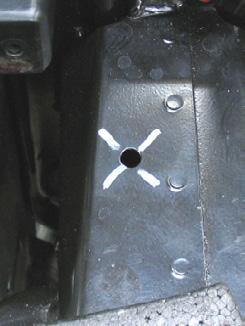 Using an existing hole on top of the metal bumper drill a hole using a 1 1/ hole saw to cut opening