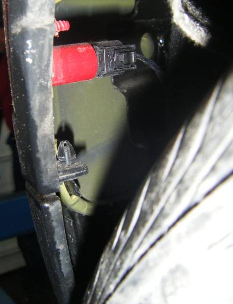 Using a phillips screwdriver remove (4) fasteners securing the mudflap, two each