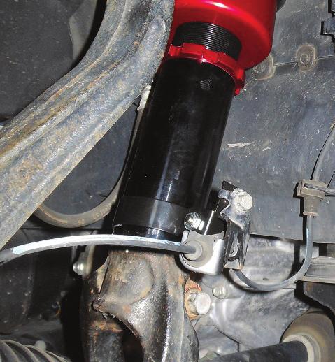 4. Align the fork mount with the lower control arm bushing and insert the previously removed bolt (fig. 12).