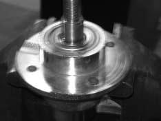 Align and install pulley and key onto spindle shaft. 5. Secure pulley and compress spindle hub assembly with top nut. 6. Tighten pulley top nut to standard torque.