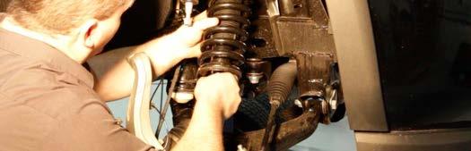 Using a pry bar to push down on the upper control arm as shown in Photo 14, hand tighten the nut. Using 6mm allen wrench to hold the stud and 18mm wrench to tighten the ball joint.