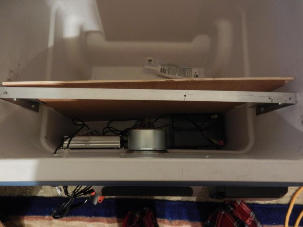 6. Once the battery is in place take the plywood and place inside the cooler.