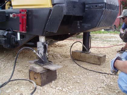 Step 3 and 4. Raising the front of the tractor 3. Using a long stroke hydraulic jack, also raise up the front end approximately 8. 4. Place 2 tall jack stands under the frame rails to firmly stabilize the tractor.