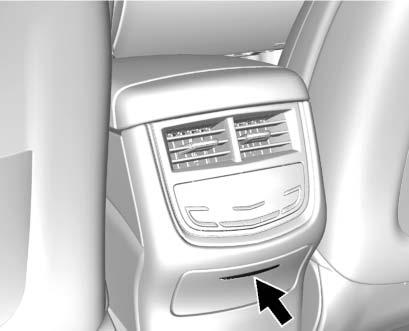 If equipped, press the top of the door to open the storage area on the rear of the centre console. If equipped, there is a power outlet inside.