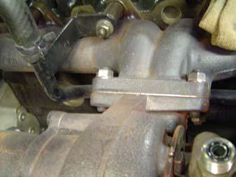 Remove the bolts on the exhaust elbow flange and set aside (Fig. 9).