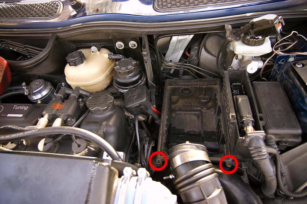 5. Remove the two T 25 screws located toward the front of the car that are holding the upper filter housing in place (Location noted by red circles).