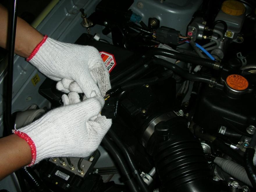com Remove the air intake scoop from the air box by unclipping the front and