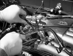 Slide the cables from their brackets and remove the cable ends from the throttle body levers. 13.