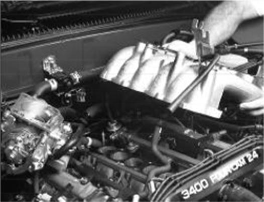 18. A pre 2000 Tacoma or T 100 may be equipped with an EGR valve. To be sure, look for this tube (see arrow, figure 14) on the driver s side exhaust manifold.