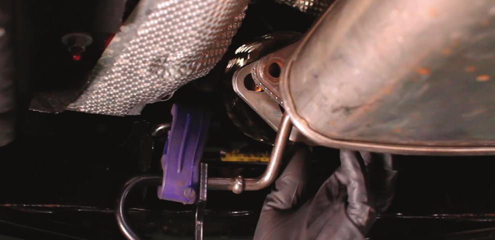 Locate the Mishimoto midpipe and exhaust gasket in your kit. Slip the hangers on the midpipe into the grommets on the body of the vehicle. 17.