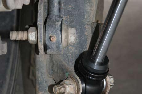 Install new rear bump stop spacer by placing the spacer on the axle pad lining up both holes with the overhang part of