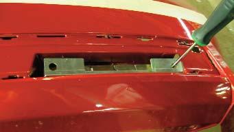 Once the screw begins to thread into the bumper cover, start the center screw.