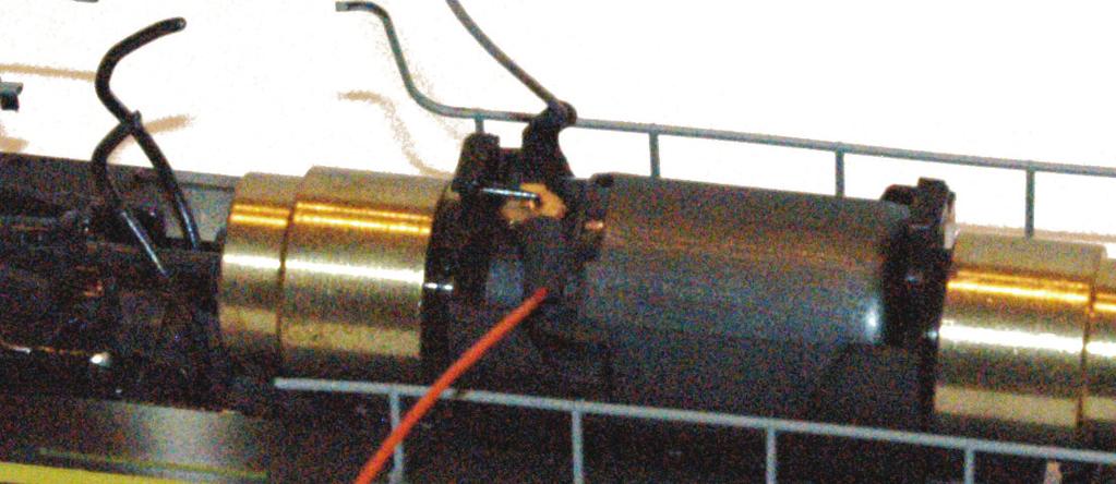 23. Next, gently clip the motor leads loose. On some models, like the one shown in Photo 19, copper strips serve as the motor leads, while in others the motor leads are simple wires.