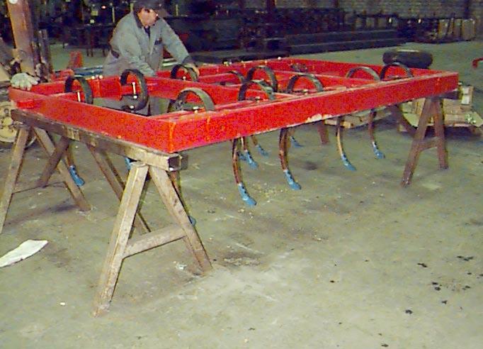 To ensure the stability of the frames and safety of the workers during assembly, place the cultivator frames on surdy steel shop stands.