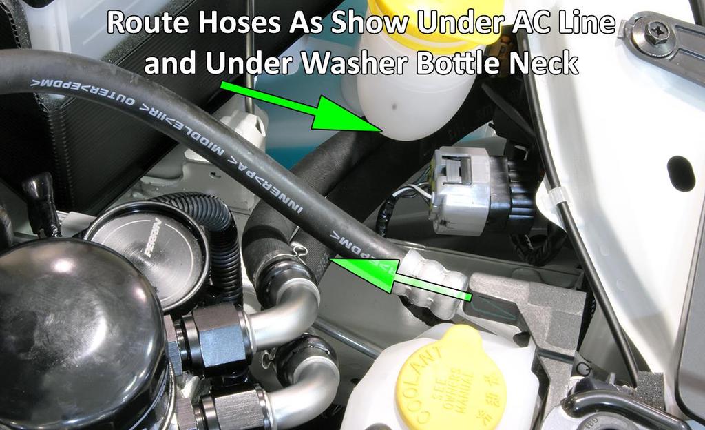 23. Locate oil cooler hose with 45 degree bend on one end. Thread this into lower fitting on oil cooler. Make sure and use two wrenches to tighten to roughly 30-40ft-lbs.