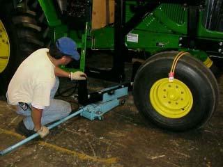Using Jack helps to align Stabilizer to frame rails. This is shown on a 2 WD Tractor for illustration and is the same for the 4 WD Frame Rail Installation 12. Align Stabilizer Kit.