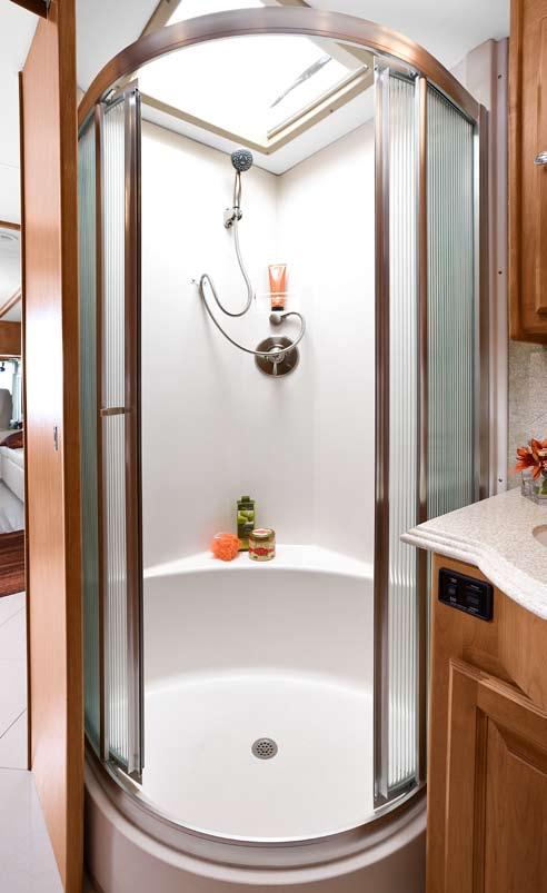 vanity. Enclosed in a stylish glass surround, the stall also features a lovely skylight equipped with a solar cover for heat and light control.