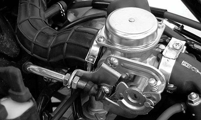 carburetor side. Adjust by loosening the lock nut and turning the adjusting nut.