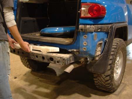The plastic bumper is held into place with plastic clips.