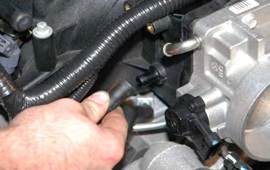 49. Disconnect the engine valley cover vent hose from the
