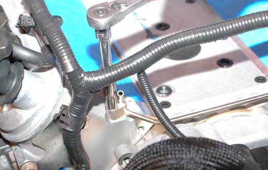 Install the new coolant vent pipe with the supplied gaskets and bolts.