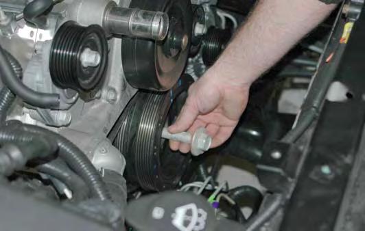 Use a torque wrench and 24mm socket to tighten the new balancer