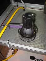 The view of the UV Lamp to the left, shows the Booth s receptacle for the Lamp, with the excess power cable neatly wrapped an hanging on it.