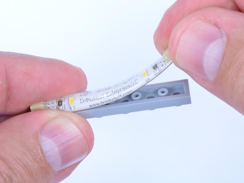 When you're ready to mount the light strip, carefully peel the adhesive backing, mount the strip, and press firmly and evenly to make sure the strip is securely attached.