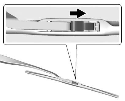 2. Lift up on the latch in the middle of the wiper blade where the wiper arm attaches. 3.
