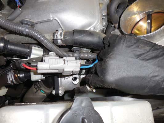 Disconnect the second coolant hose shown with