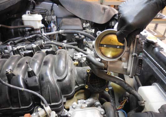 Remove the throttle body and hoses from the