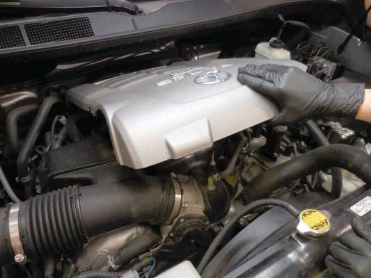 5. Remove the engine cover. Lift up at the front of the cover, and then pull away from the fi re wall. 6.