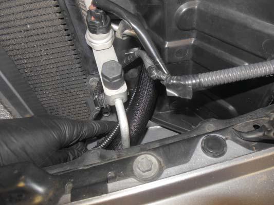 225. Route the relay wiring harness through the lower cutout in the left radiator deflector, following the