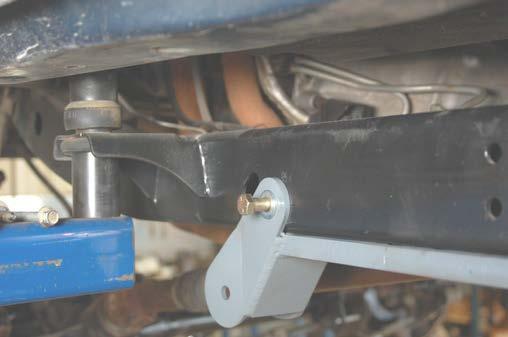 25. Align the holes in the frame with the new control arm bracket and install the factory skid plate bolts.