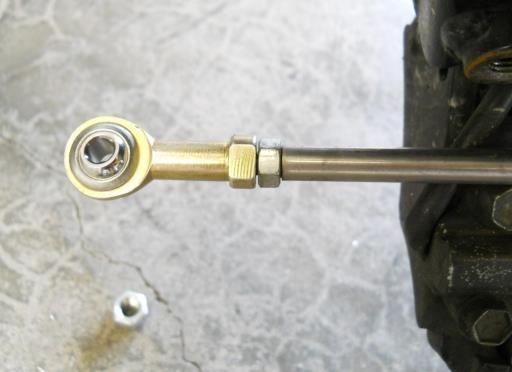 pedal. Thread the right hand threaded nut from the old shifter linkage onto one end of the new Shifter Linkage.