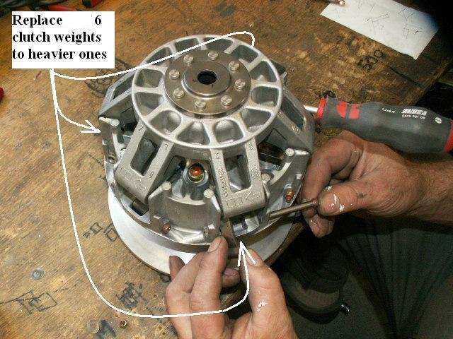 (see picture) Replace the clutch weights to the new heavier ones supplied with the kit.