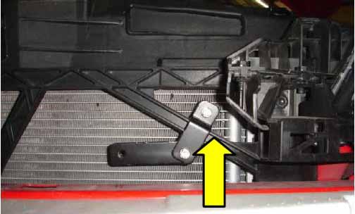 4. Loosely install the Cobb power steering cooler line relocation bracket around the plastic radiator core