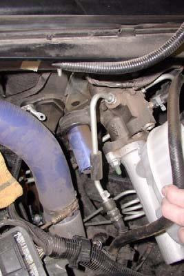 d. Carefully bend power assist pressure line up toward hood, to clear accumulator on brake hydro boost.
