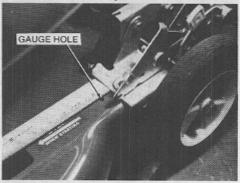This can be accomplished by measuring the distance from the front edge on the height adjuster brackets to the' 1/4" diameter gage holes locatedirectly