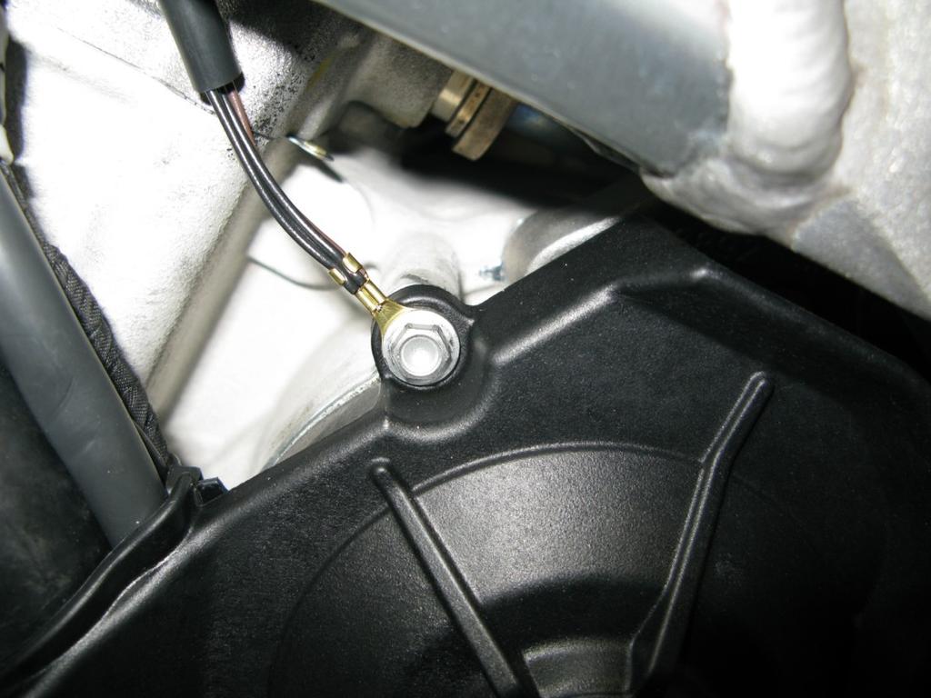 8. While working on the left side of the bike, route the ground lug lead of the Bazzaz harness between the frame and engine