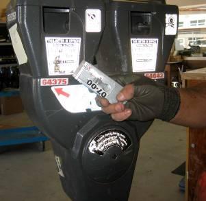 Fig. 6: Scraping illegible or out of date decals from a meter before reapplying. Fig.