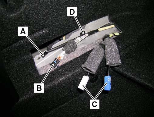 2. 3. In the left side of the load compartment, find and identify: Power supply (A, Figure 8) SDARS MOST connector (B,