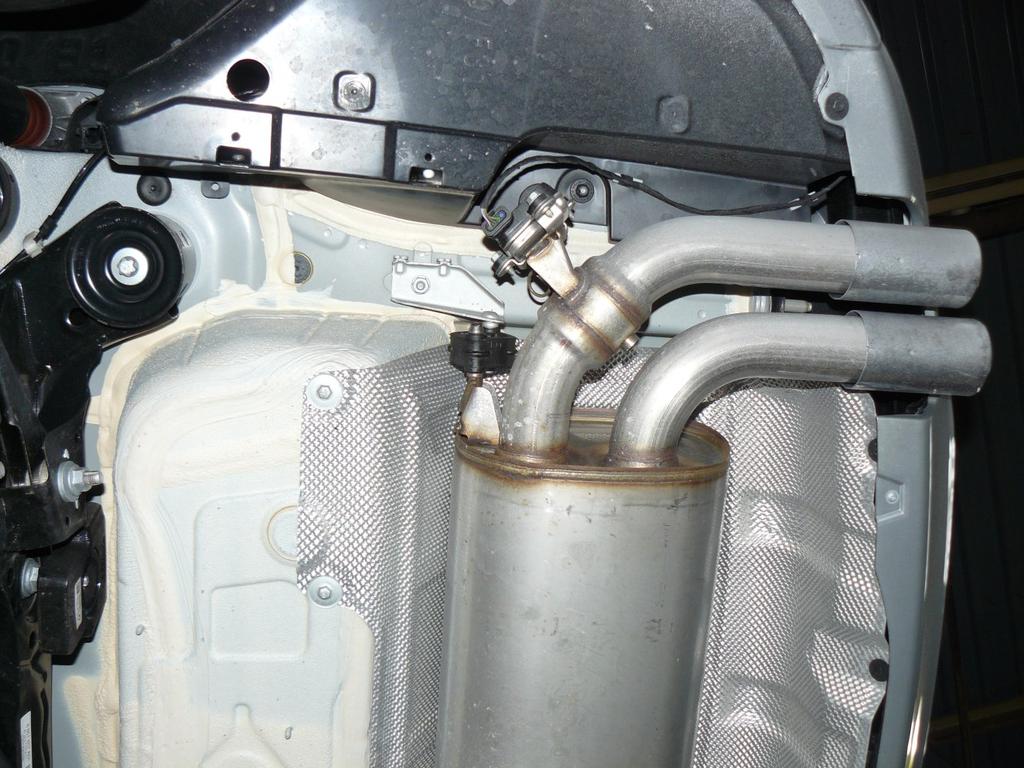 To remove the factory exhaust, spray penetrating oil on the cat-section exhaust clamp before loosening the nut, at Arrow A in Figure 1.