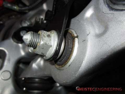 9. Remove the nut and bolt that fasten the strut to the control arm 10.